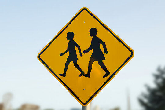 School Sign Showing Children Crossing The Road Safely