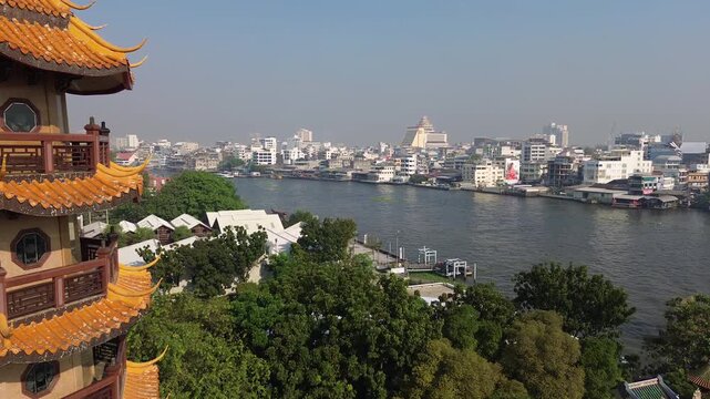 Aerial view of Wat Che Chin Koh temple tower and Chao Phraya river, Bangkok, Thailand, 4k