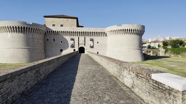 Rocca Roveresca Castle of Senigallia, Ancona and its access bridge, with full day light in summer time. Building recently cleaned in 2026. Front side view, horizontal footage panning.