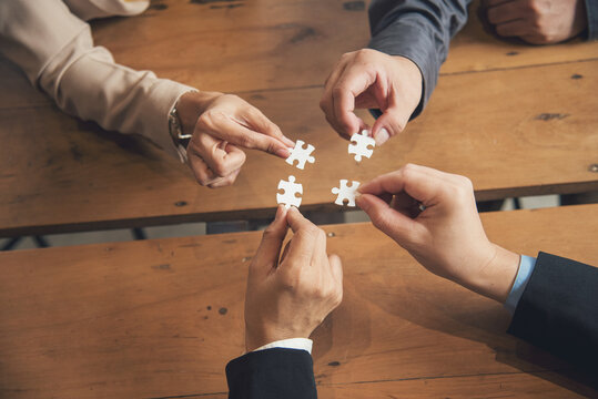 Business jigsaw puzzle connections strategy synergy team solution. Stakeholders business trusted communicate teams hands holding jigsaw puzzle synergy. Implement puzzle communication solve synergy