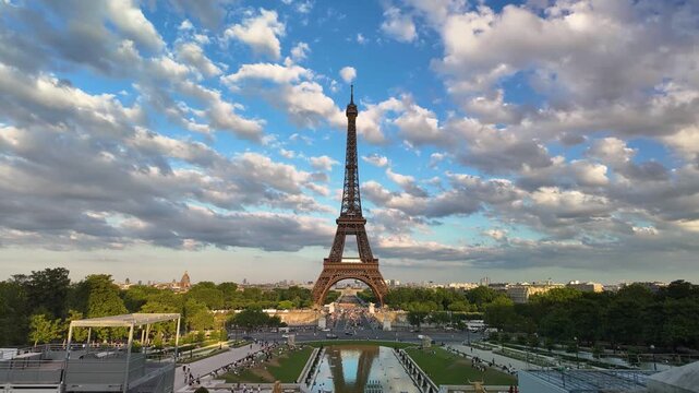 A scenic daytime timelapse video of the iconic Eiffel Tower captured from Trocadero under a dramatic moving cloudy sky.