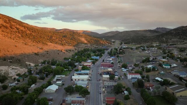 Eureka Nevada - Aerial Approach of Downtown Eureka NV at Sunset Facing South with Glow on Mountainside