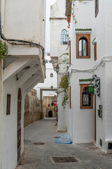 Fototapeta premium Morocco - Tangier - Kasbah - Whitewashed Alley with Overhanging Balcony
