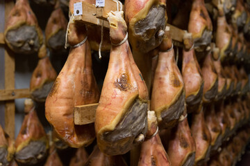 Storage of prosciutto in a ham factory in Bologna, Italy © Maria