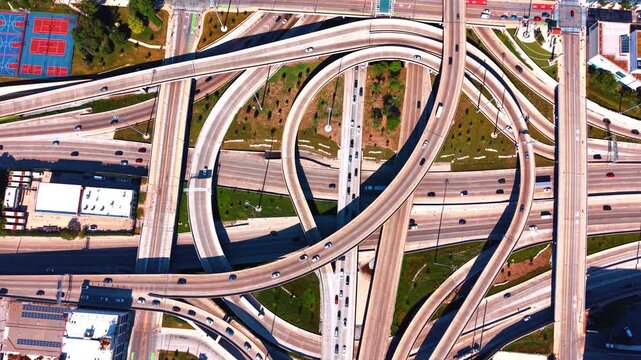 The Jane Byrne Interchange located in downtown Chicago, Illinois. Numerous cars move by the interchange with concrete flyover ramps and loop bridges. Top view.