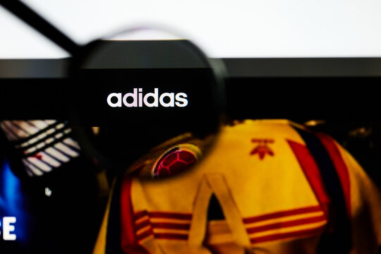 Milan, Italy 2026, 5 Jul Closeup of Adidas website page on a laptop screen. Focus on Adidas logo under a magnifying glass.