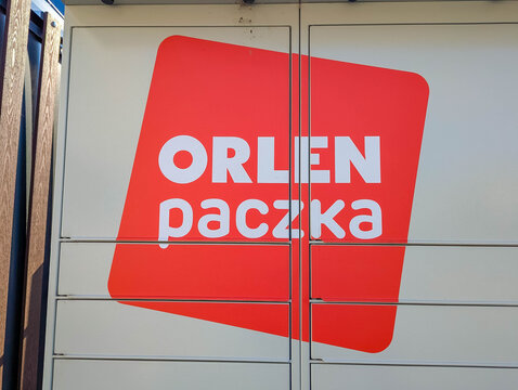 Warsaw, Poland,May 03, 2026. Side corporate orange logo sign of Orlen Paczka parcel delivery service on a transport trailer vehicle. High quality photograph.