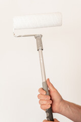 Obraz premium Room renovations. White paint for walls. Hand Painting Wall With Roller 