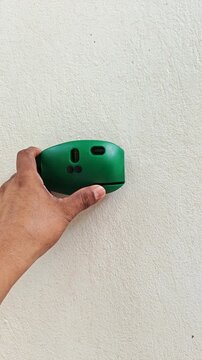 Mounting laser level tool on wall for construction measurement