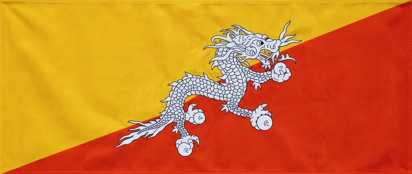 Flag of Bhutan featuring a white dragon against a background of yellow and orange