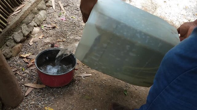 Filling plastic container water bowl for dog hydration outdoor