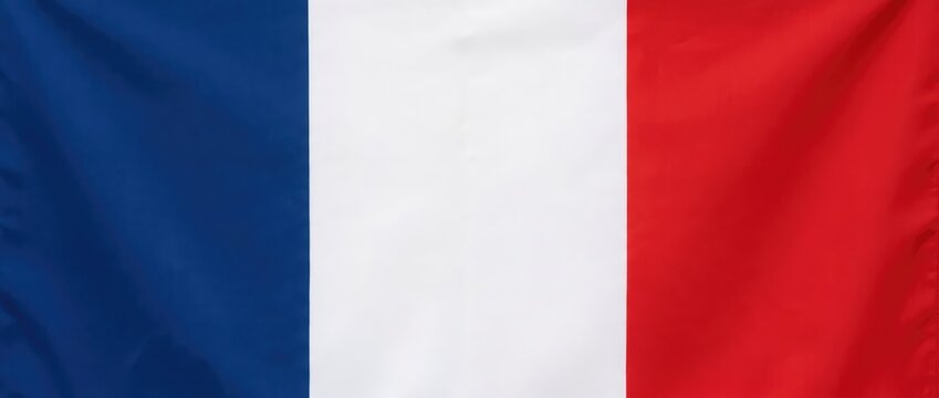 Close-up of the French flag with its iconic blue, white, and red vertical stripes waving gently