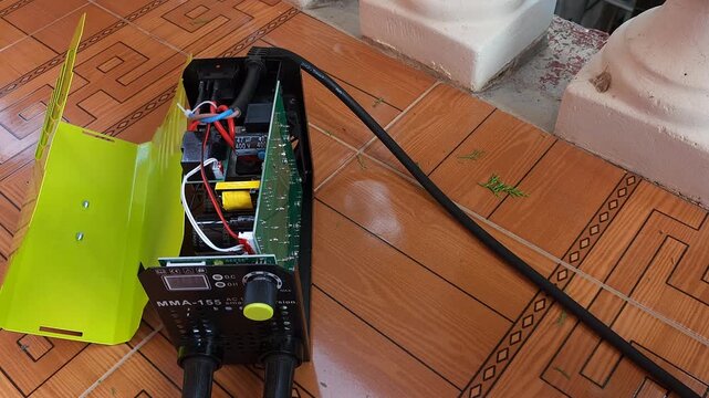 Removing metal protective casing cover to open mini welding machine