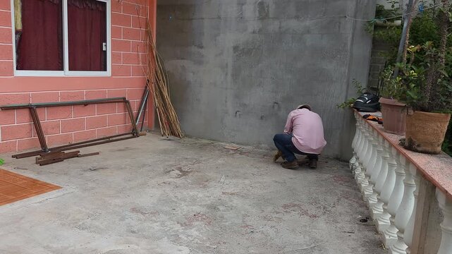 Welder worker picking up and organizing tools after job completion