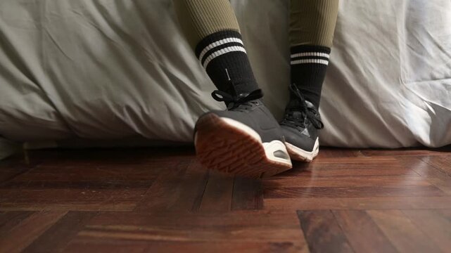 Woman taking off sneakers after workout routine
