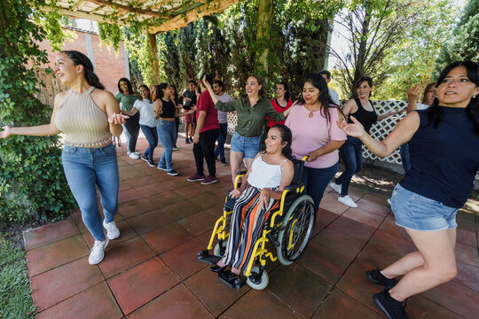 Group of latino friends enjoying a salsa dancing class outdoors in Mexico Latin America. Hispanic people moving to the rhythm and having a fun together