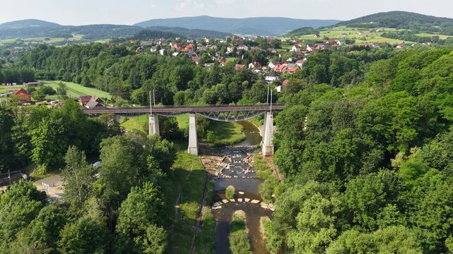 Aerial footage of railway viaduct over Biala river in Grybow town, Poland