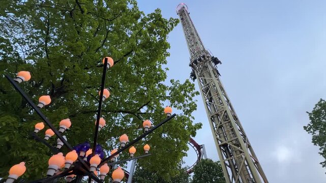 Low angle view of drop tower ride at Tivoli Gardens in Copenhagen, Denmark
