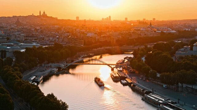 Panoramic aerial view of Paris skyline with Seine River and bridges at golden hour sunset