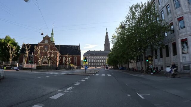 Front view of street traffic by Christiansborg Palace in Copenhagen, Denmark
