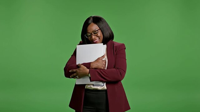 Confident Black Female School Administrator in Burgundy Blazer Holding Documents Smiling Against Green Screen Background