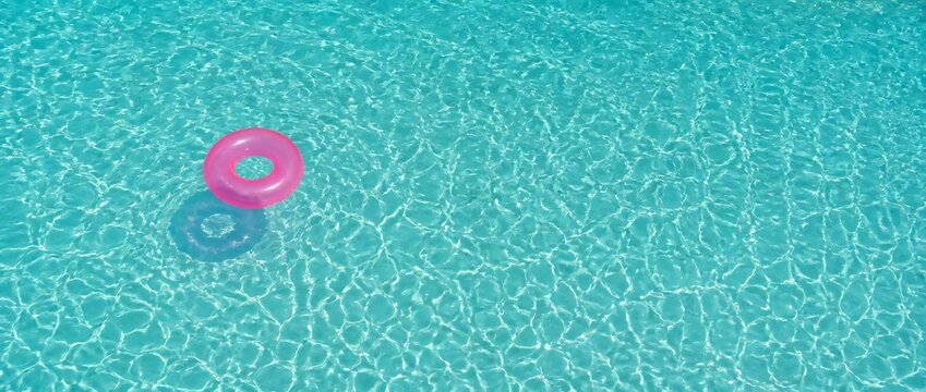 A blue pool with a pink float in it. The pool is full of water and the float is floating on top