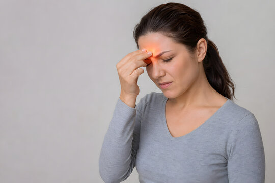 Woman experiencing frontal sinus headache and forehead pain