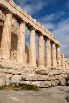 ancient Parthenon stands tall under a blue sky in Athens, Greece during midday with clouds in the background