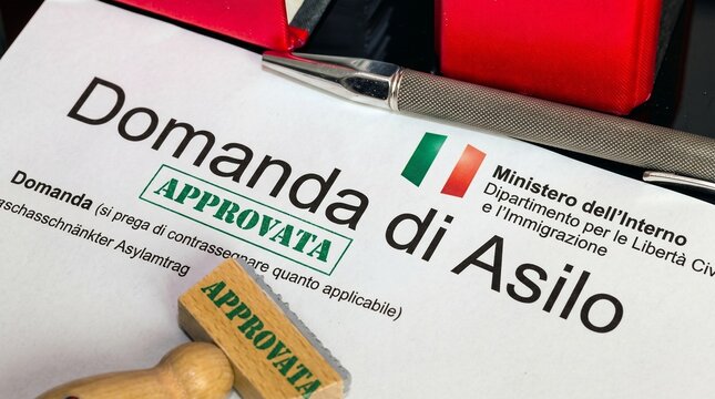 Approved asylum application, Italian immigration document, Domanda di Asilo, official government paperwork with 'APPROVATA' stamp, refugee status granted, legal migration concept