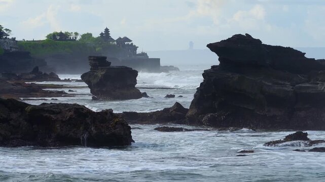 Rough Waves Rocky Coastline Tanah Lot Temple Silhouette With Pounding Surf, Windblown Spray And Bouldered Foreground, Dramatic Clouds, High Tide Motion, Cinematic Seascape For Travel And Storm Footage