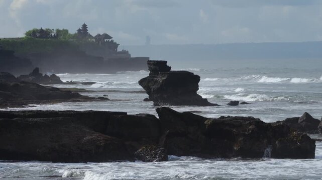 Majestic Sea Outcrop With Temple Silhouette, Powerful Swell And Crashing Surf, Layered Cliffs Receding Into Mist, Distant Balinese Shrine On Headland, Moody Clouds And Dramatic Light, Tanah Lot