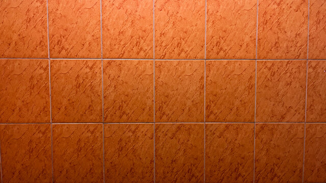 Side view of orange bathroom ceramic walls. front. close up. copy space, empty, free, negative, text, design. background, backgrounds. nobody, no people. light, bright. home, house. floor.