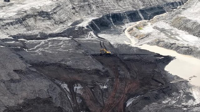 Activity of loading coal into transport trucks in the blackened coal mining area