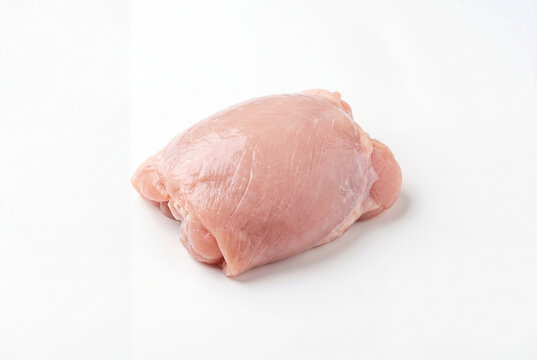 Single raw boneless skinless chicken thigh on white background
