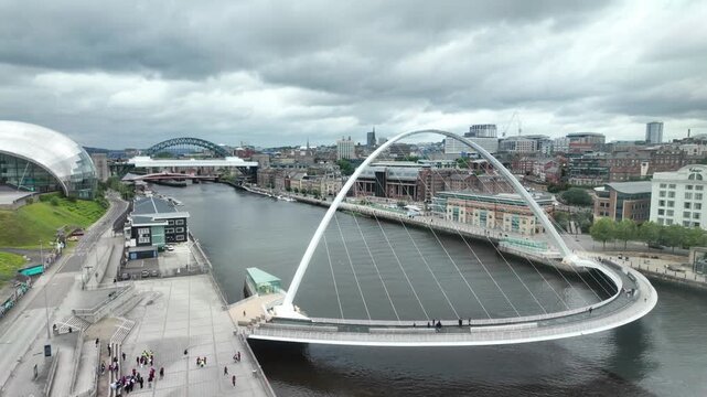 The tilting Gateshead Millennium Bridge crossing the River Tyne, connecting the Quayside areas of Newcastle and Gateshead.