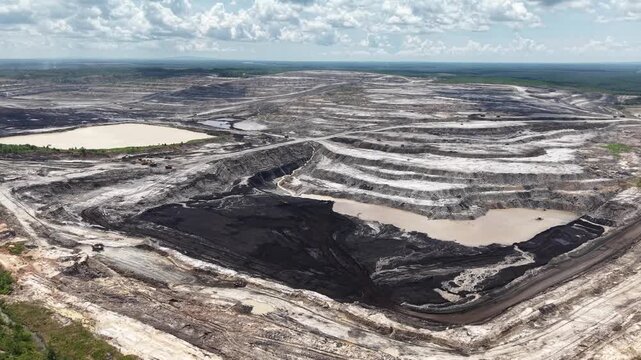 Activity of loading coal into transport trucks in the blackened coal mining area