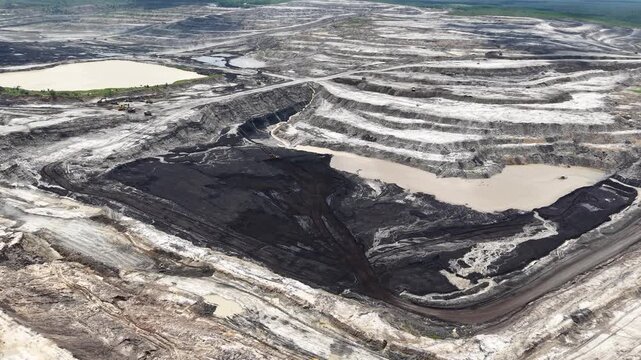 Activity of loading coal into transport trucks in the blackened coal mining area