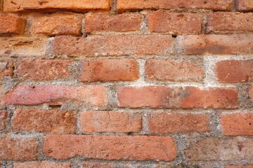 Fototapeta premium Aged brick wall texture with rustic architectural pattern.