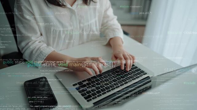 A woman is focused on programming while using a laptop in a bright home office. Code and data are visible on the screen, capturing the essence of modern software development. Xenic
