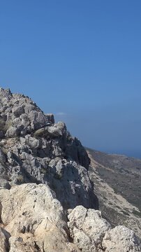 Vertical video of Platiskinos mountain range over Balos lagoon. Crete, Greece.