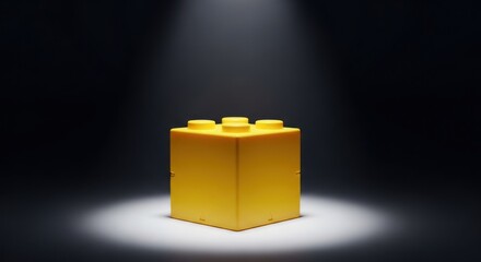Obraz premium Yellow Lego Brick Under Spotlight Alone.