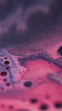 Vertical video. Shimmer art. Oil texture. Defocused pink purple color paint in water marble sparkling liquid droplet floating on abstract background.