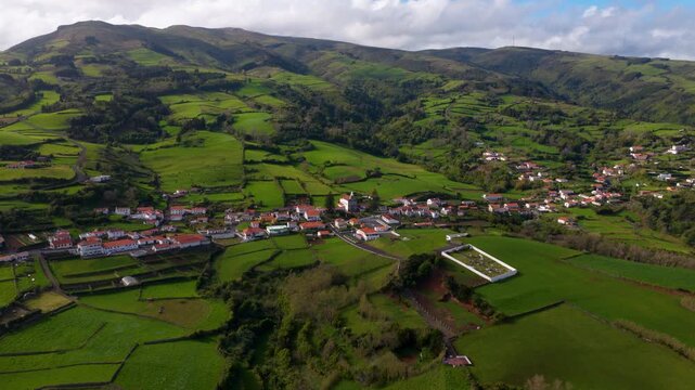 Picturesque Village In Green Volcanic Landscape Of Lajes das Flores In Azores, Portugal. wide aerial shot