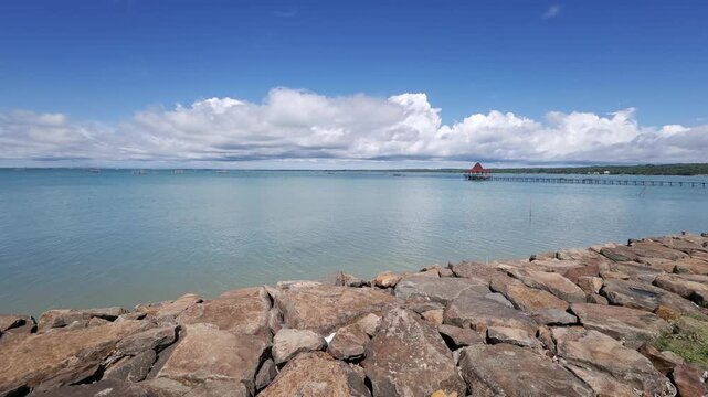 Rocky Shoreline at Tanjung Lesung Beach Indonesia, Coastal Panning View