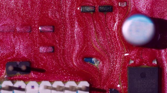 Processor detail. Glitter stream. Red yellow paint spill on technological texture. Modern color abstract blur circuit art background.