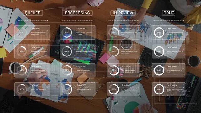 Aerial view of a diverse team engaged in a productive meeting, utilizing project management tools and charts to track tasks and analyze performance on a wooden table. Raster