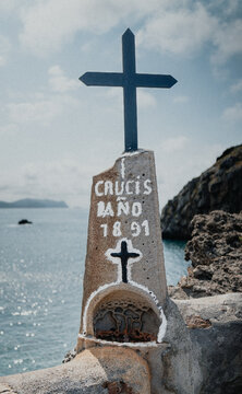 Old Cross in Front of Rocky Coast