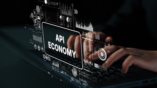 Hands Typing on Laptop with Digital Interface and API Economy Concept Visualization in Modern Workspace. Asymptotic smart data analytic.