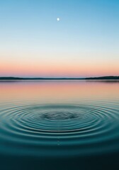 Obraz premium Peaceful Lake Landscape at Sunset with Concentric Water Ripples and Moon in Clear Twilight Sky Background