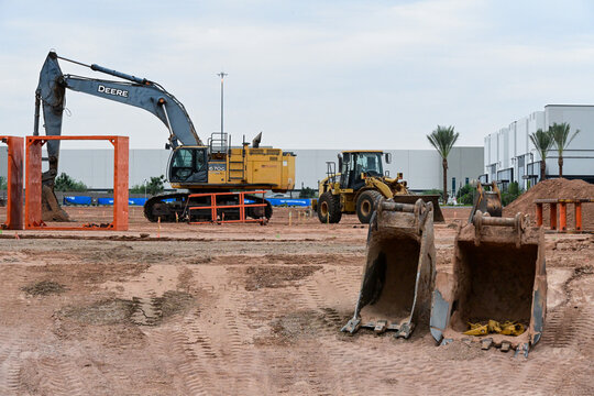Excavator, loader, and heavy equipment buckets at a construction site, illustrating excavation, earthmoving, site preparation, land development, and construction operations